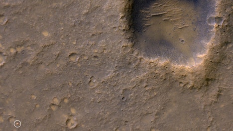 A NASA probe orbiting Mars has captured new photos of two dead spacecraft frozen in place at their Red Planet graves.